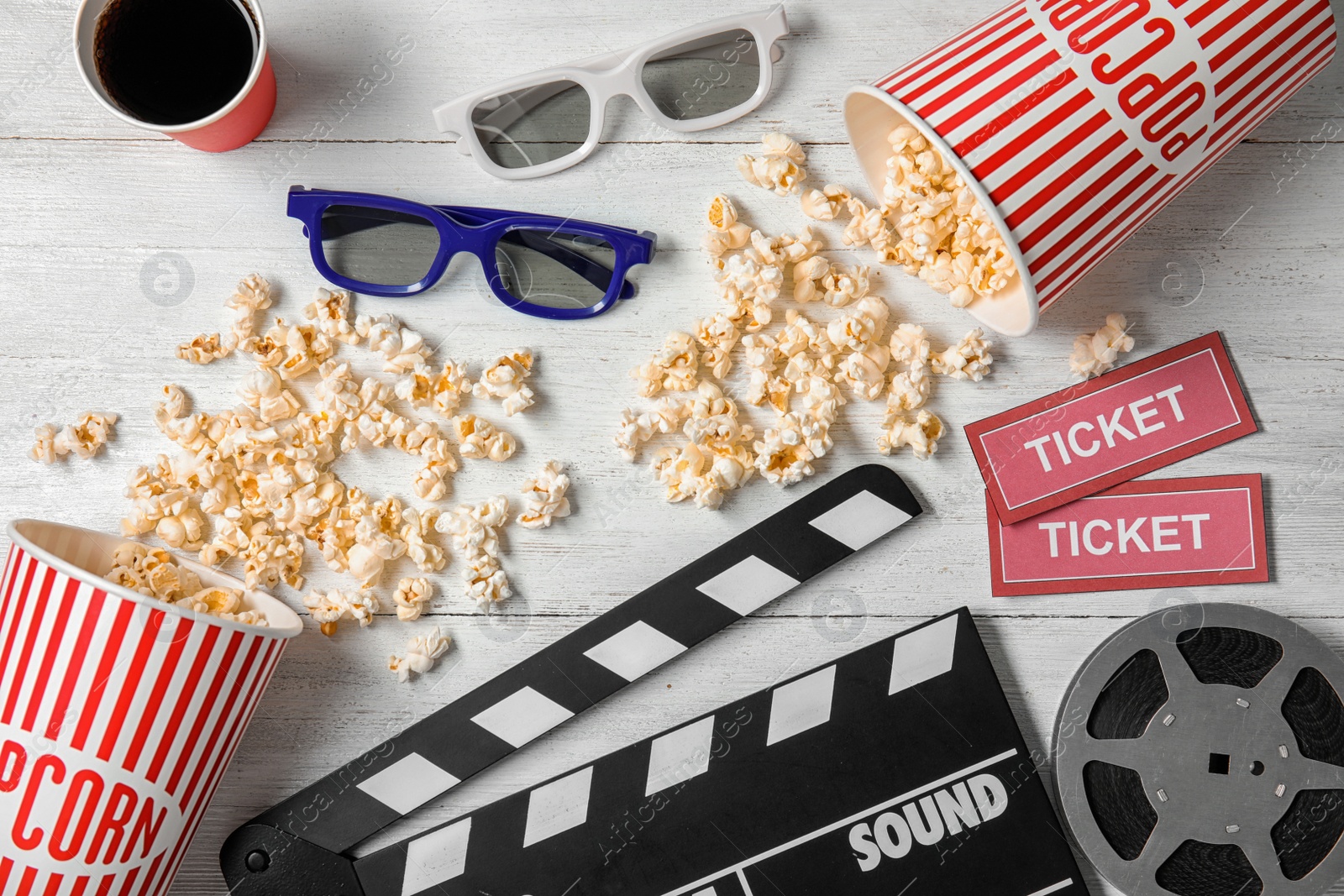 Photo of Flat lay composition with clapper, popcorn and tickets on wooden background. Cinema snack