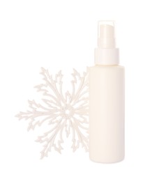 Photo of Bottle of hand cream and snowflake isolated on white. Winter skin care