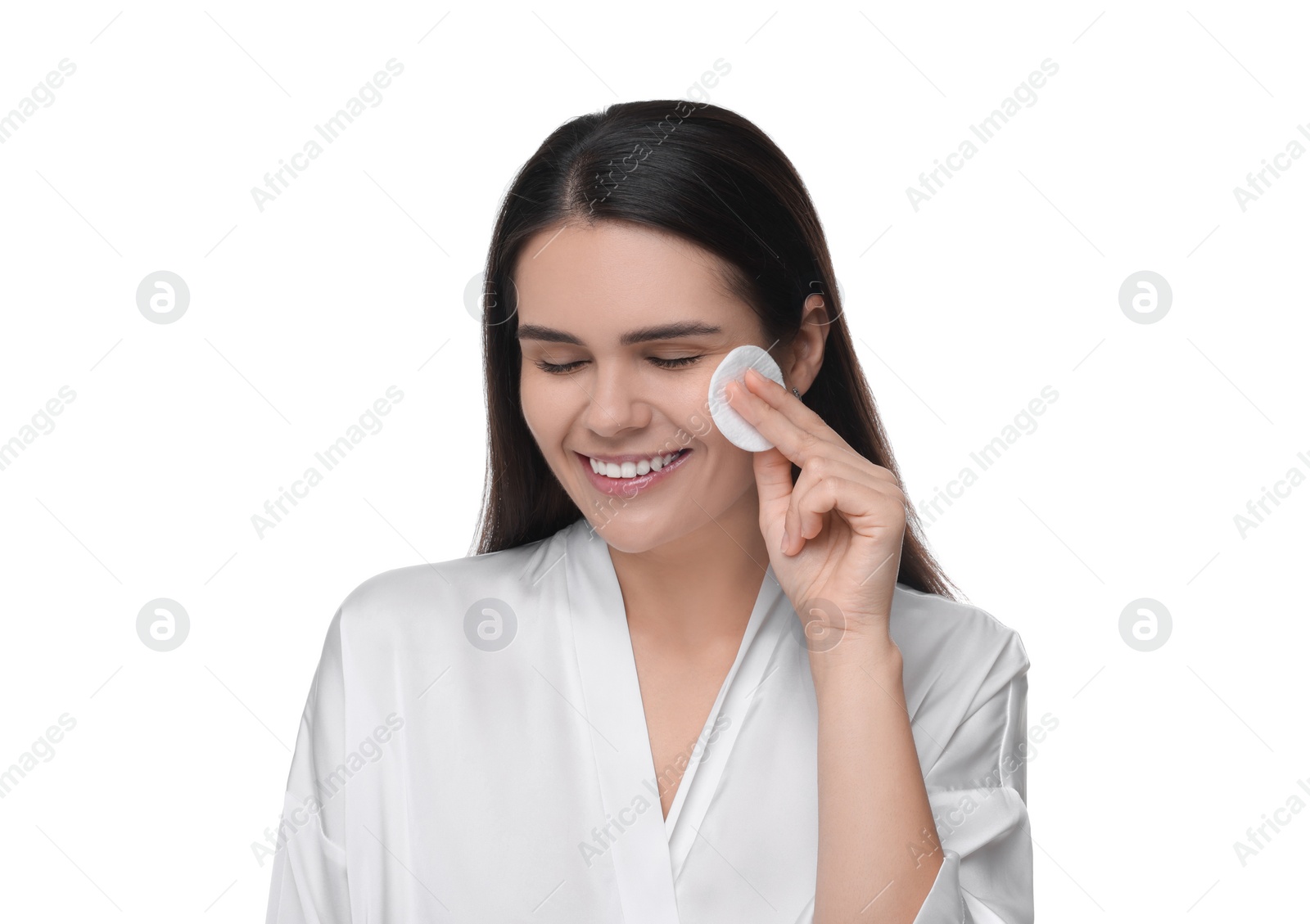 Photo of Young woman cleaning her face with cotton pad on white background