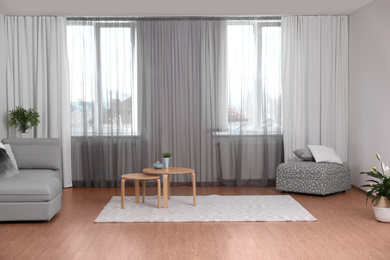 Photo of Windows with stylish curtains in living room interior