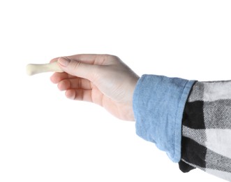 Photo of Woman holding bone shaped dog cookie on white background, closeup