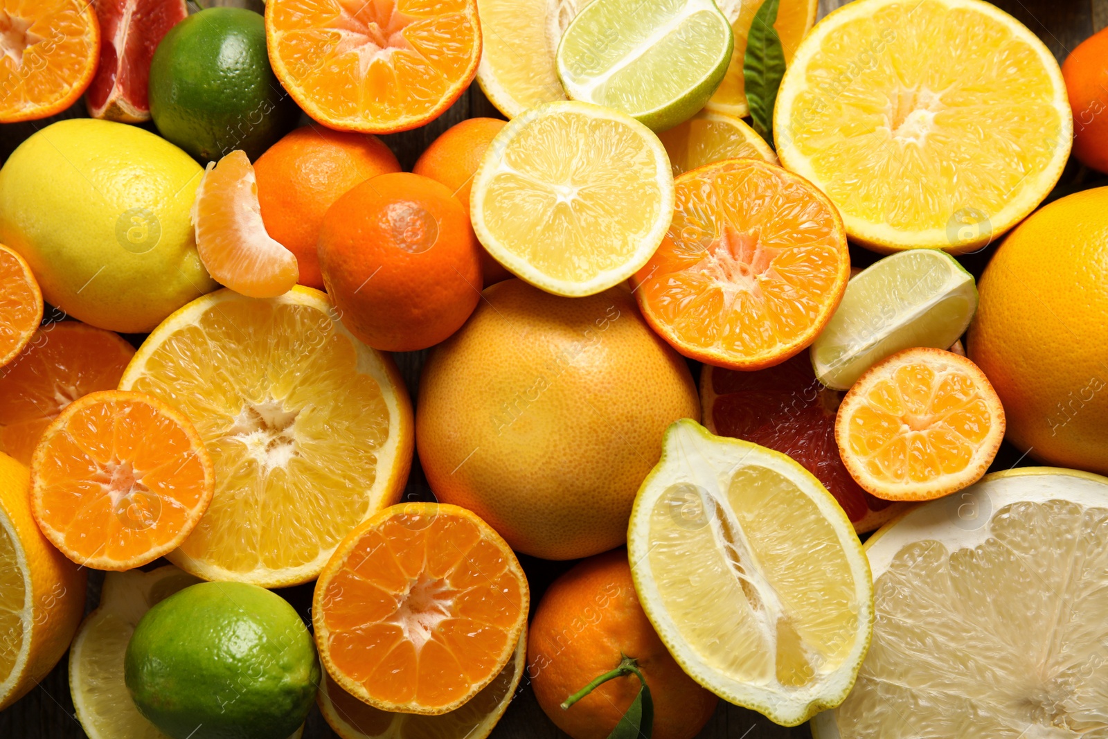 Photo of Different citrus fruits as background, top view