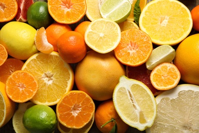 Photo of Different citrus fruits as background, top view