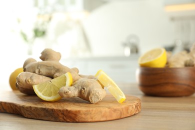 Photo of Fresh lemon and ginger on wooden table indoors, space for text