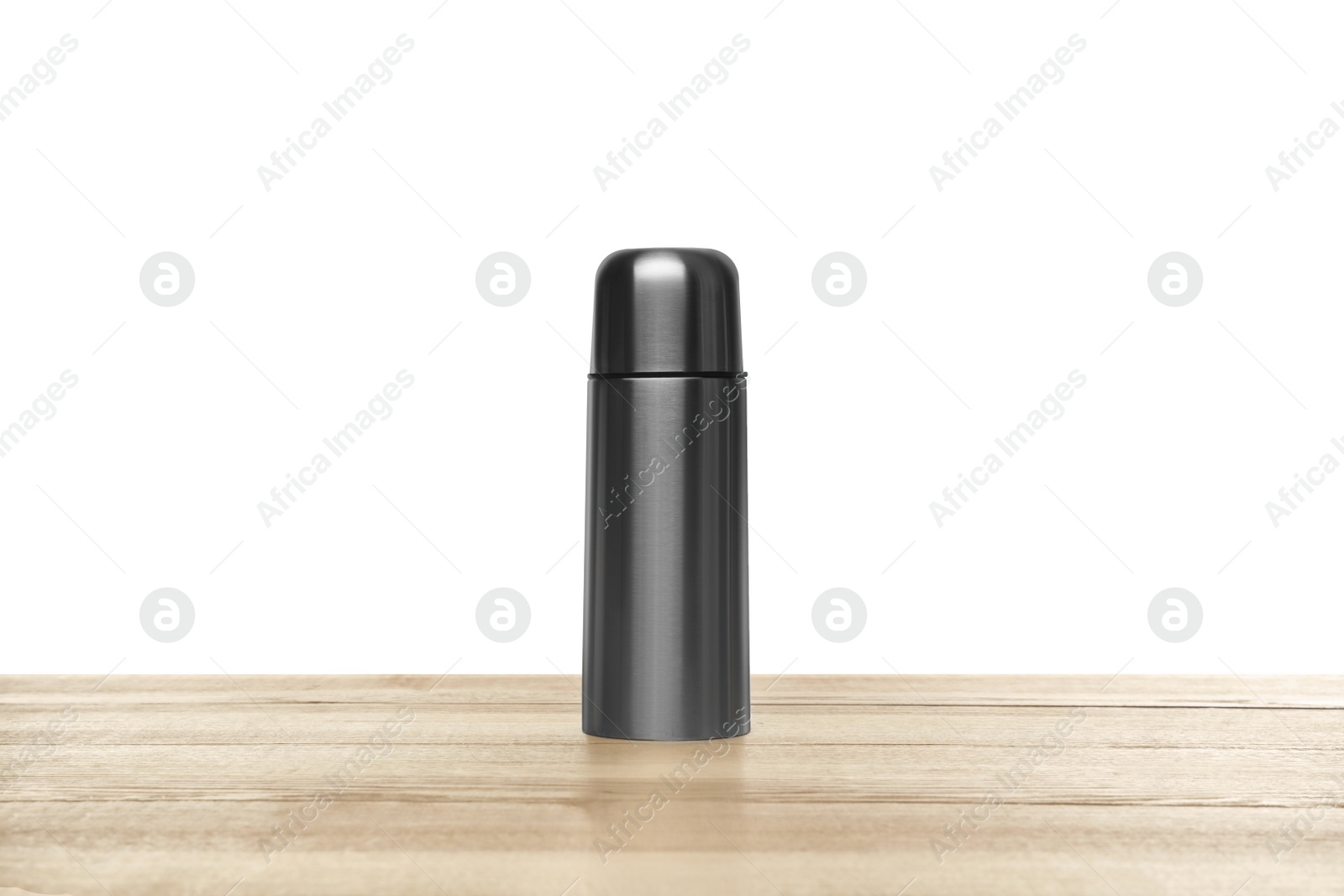 Photo of Stylish thermo bottle on wooden table against white background