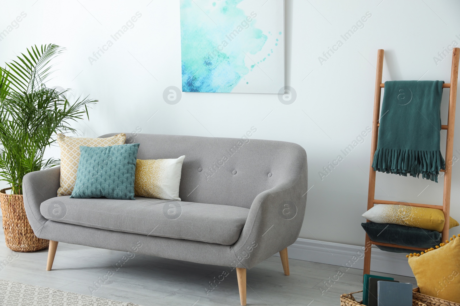 Photo of Different soft pillows on sofa in living room