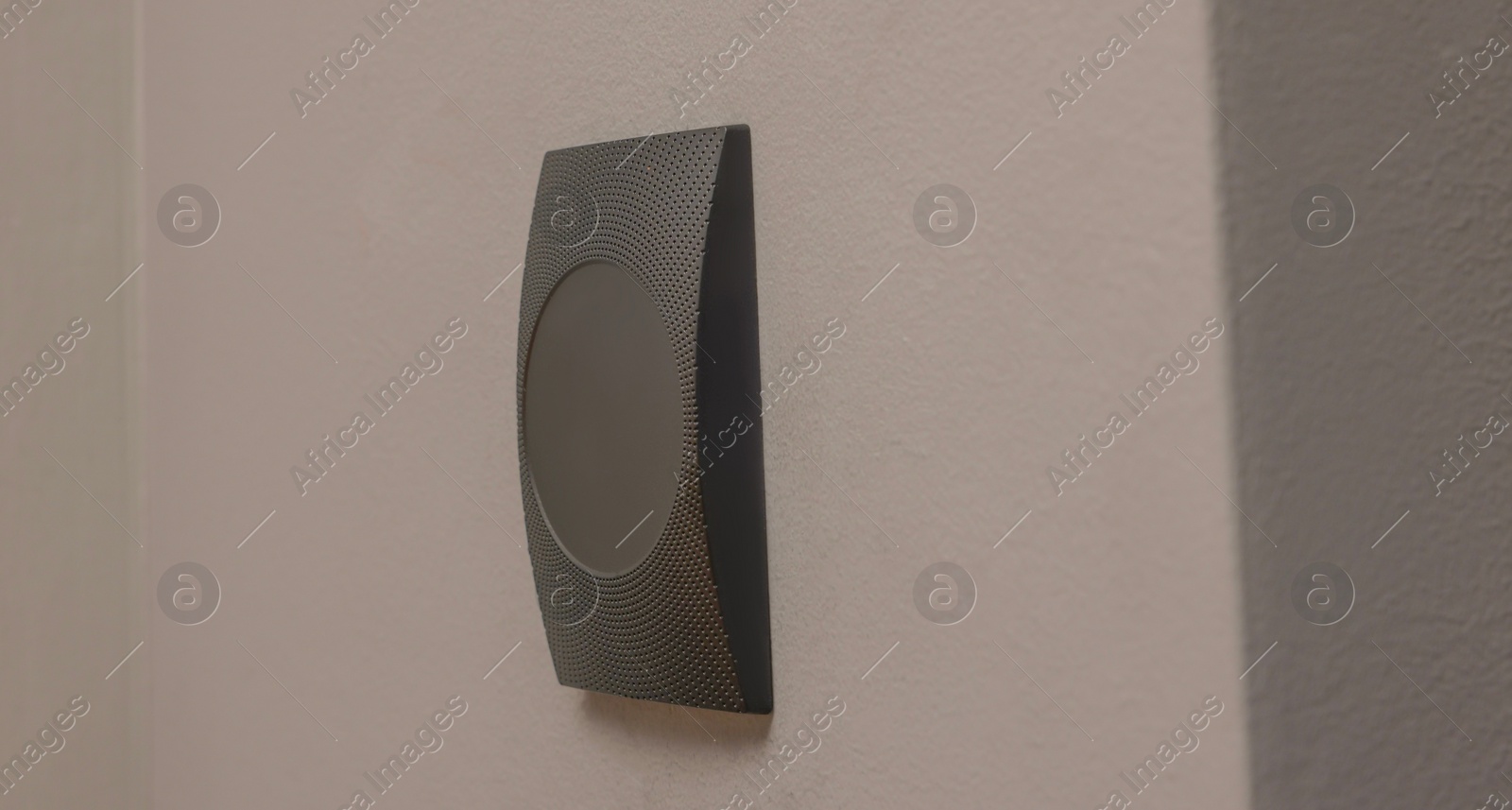 Photo of Magnetic door lock on grey wall. Home security