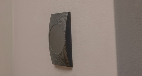 Magnetic door lock on grey wall. Home security