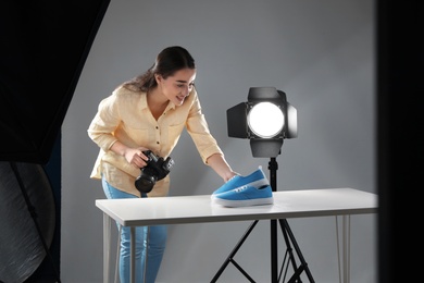 Professional photographer shooting stylish shoes in studio