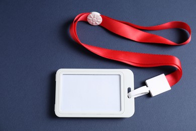 Photo of Blank badge with string on blue background, top view