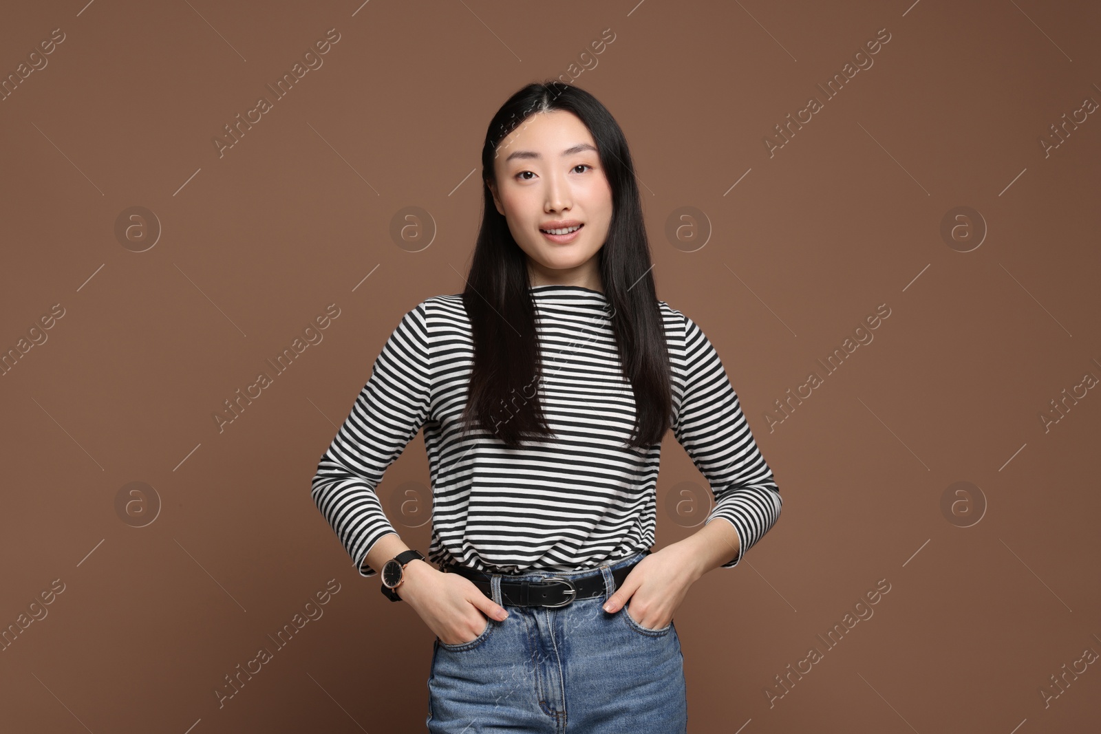 Photo of Portrait of smiling woman on brown background