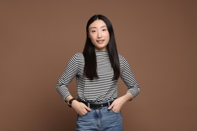 Portrait of smiling woman on brown background