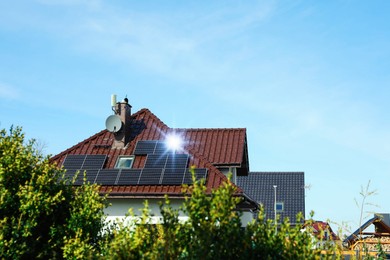 Photo of House with installed solar panels on roof, space for text. Alternative energy