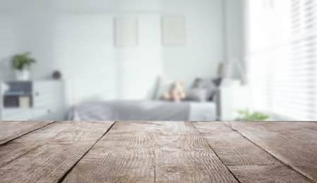 Image of Empty wooden table in baby room interior