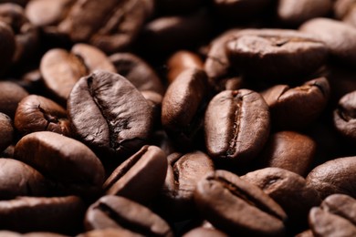 Photo of Aromatic roasted coffee beans as background, closeup