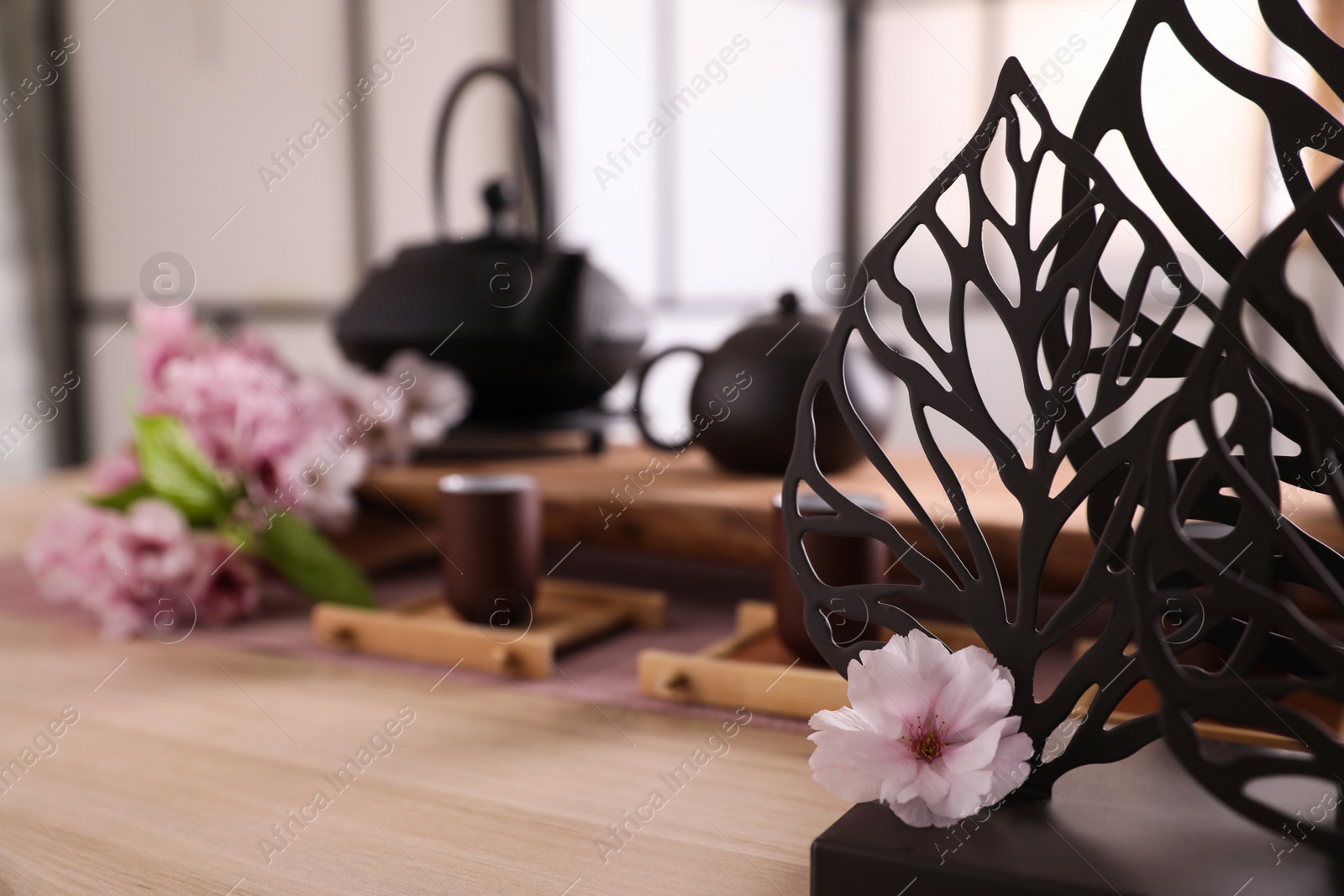 Photo of Beautiful set for tea ceremony, focus on decor and sakura flower