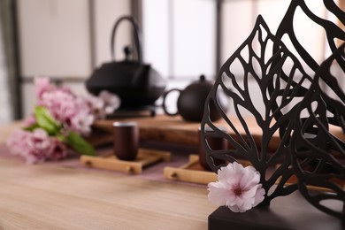Beautiful set for tea ceremony, focus on decor and sakura flower
