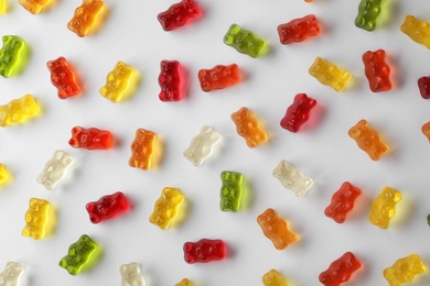 Delicious color jelly bears on white background, top view