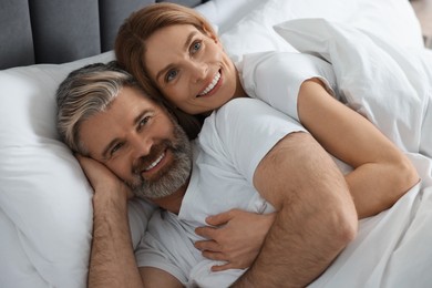 Photo of Lovely mature couple in bed at home