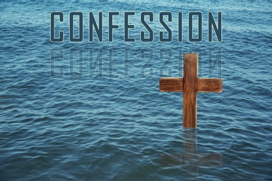 Image of Word Confession near wooden Christian cross in water