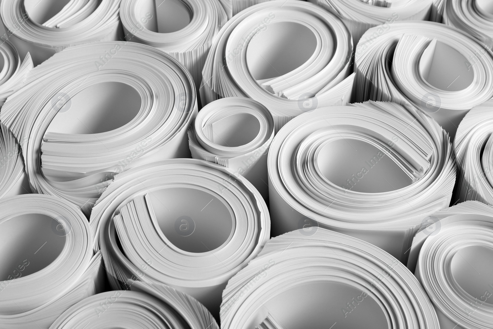 Photo of Rolled white paper sheets as background, closeup