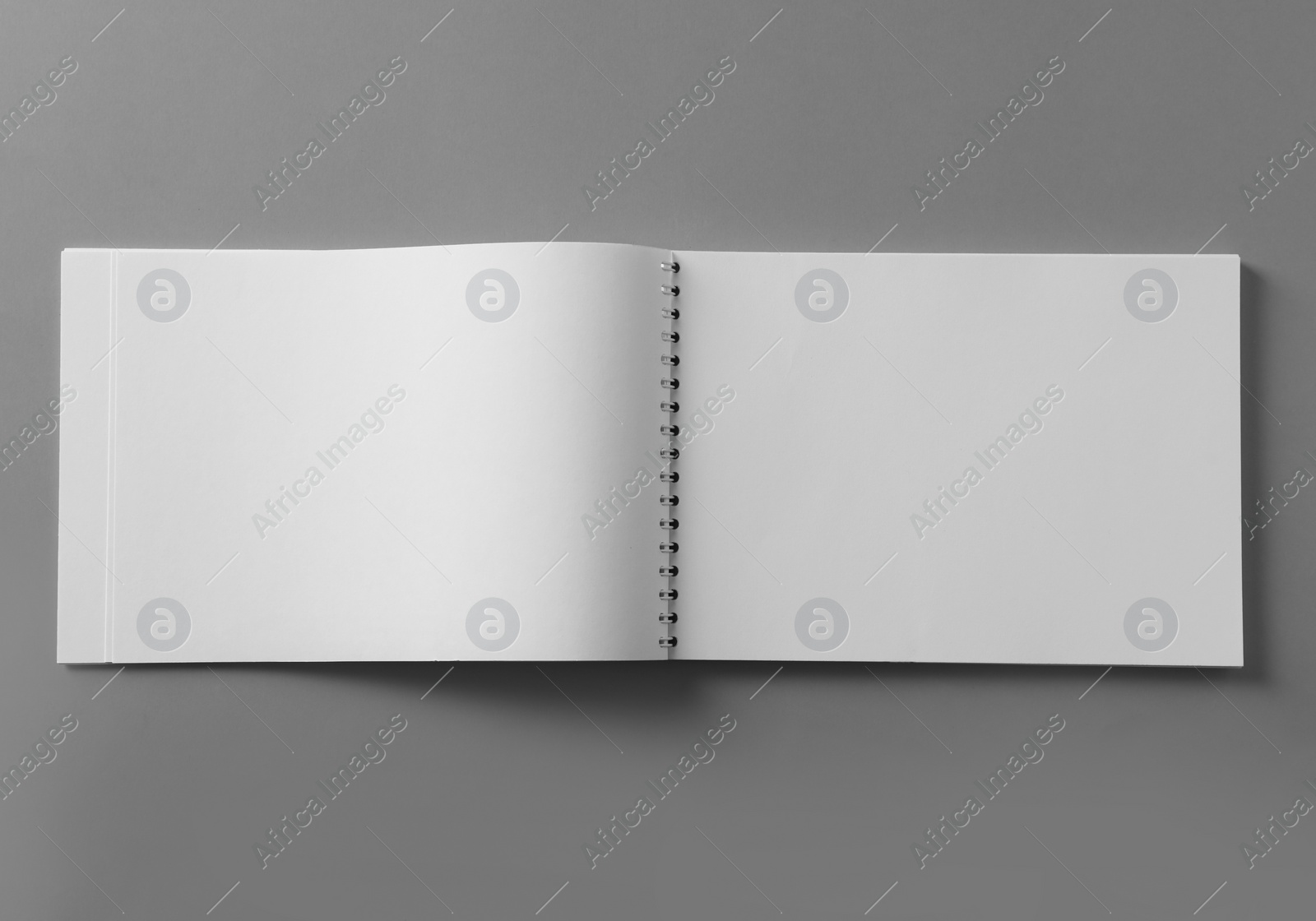 Photo of Blank notebook on light grey background, top view. Mockup for design