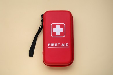 Photo of Medicine bag on beige background, top view. First aid kit