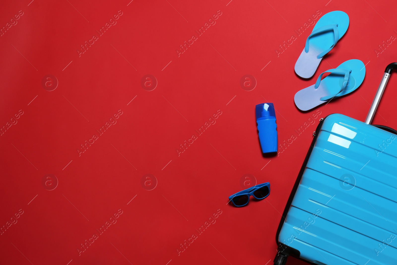 Photo of Flat lay composition with stylish suitcase and accessories on color background. Space for text