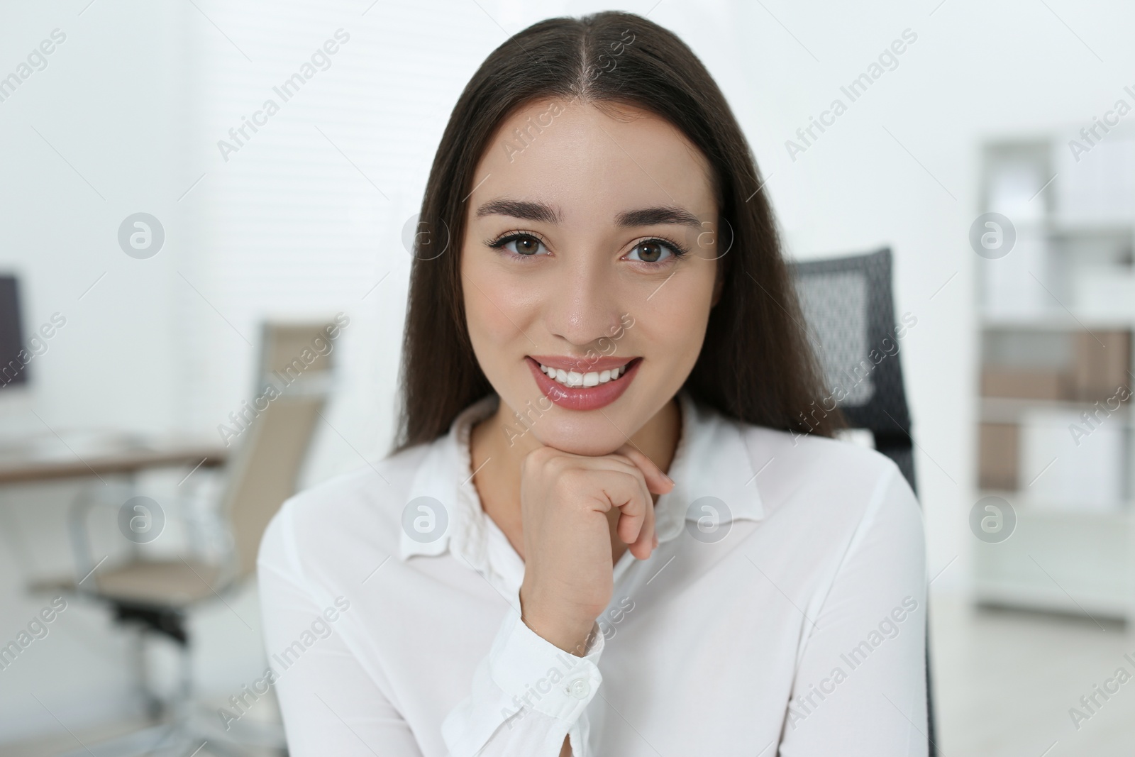 Photo of Portrait of beautiful young woman in office