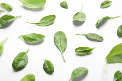 Photo of Fresh green healthy spinach leaves on white background