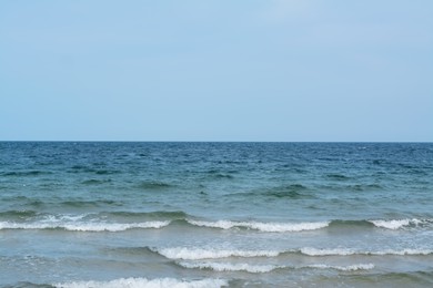 Picturesque view of sea with waves and blue sky