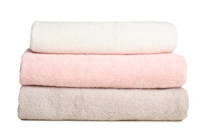 Photo of Folded soft terry towels on white background