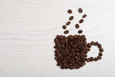 Cup made of beans on white wooden table, flat lay with space for text. Coffee Break