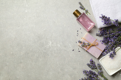 Photo of Cosmetic products and lavender flowers on light table, flat lay. Space for text