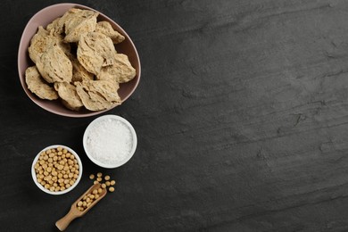 Photo of Flat lay composition with dried soy meat on black table. Space for text