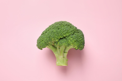 Photo of Fresh tasty broccoli on pink background, top view