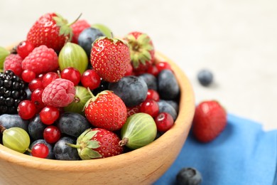 Photo of Mix of ripe berries in bowl, closeup