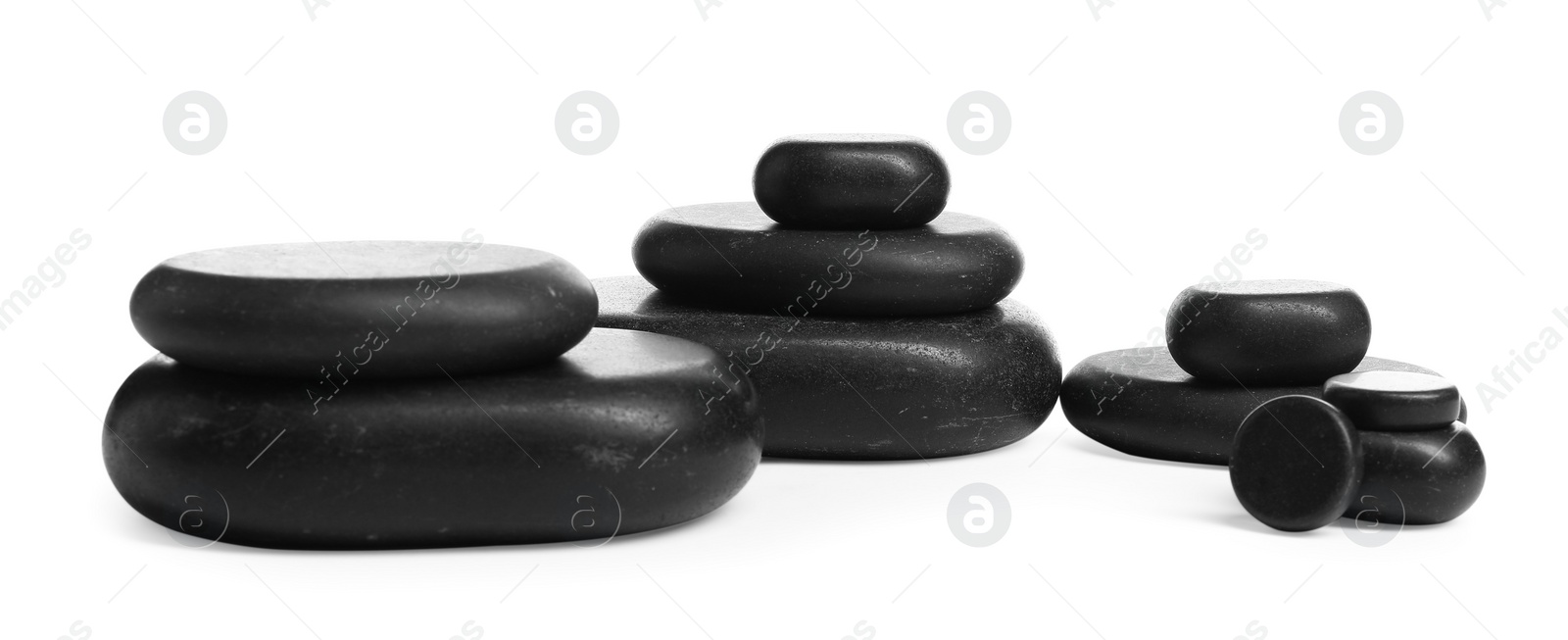 Photo of Many stacked black stones isolated on white