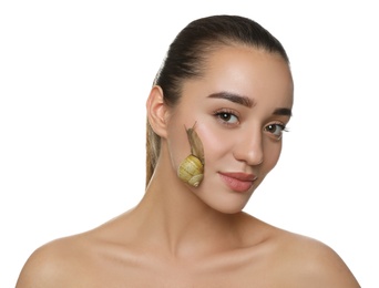 Beautiful young woman with snail on her face against white background
