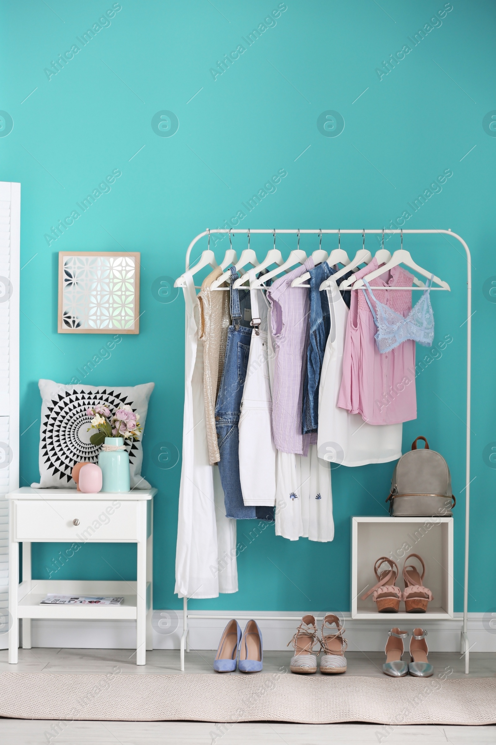 Photo of Stylish dressing room interior with clothes rack