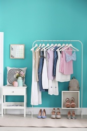 Photo of Stylish dressing room interior with clothes rack