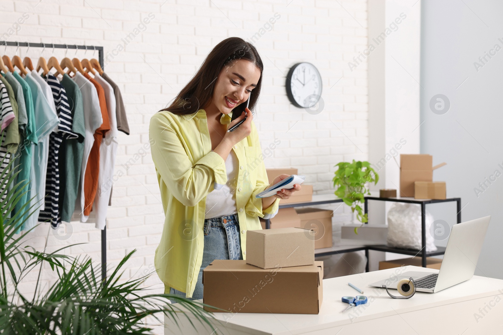 Photo of Seller talking on phone while working in office