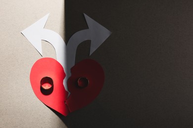 Photo of Divorce concept. Paper heart, arrows and rings on light grey background, flat lay with space for text