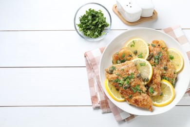 Photo of Delicious chicken piccata on white wooden table, flat lay. Space for text