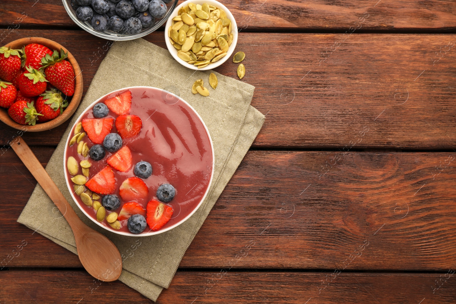 Photo of Flat lay composition with delicious smoothie and ingredients on wooden table. Space for text