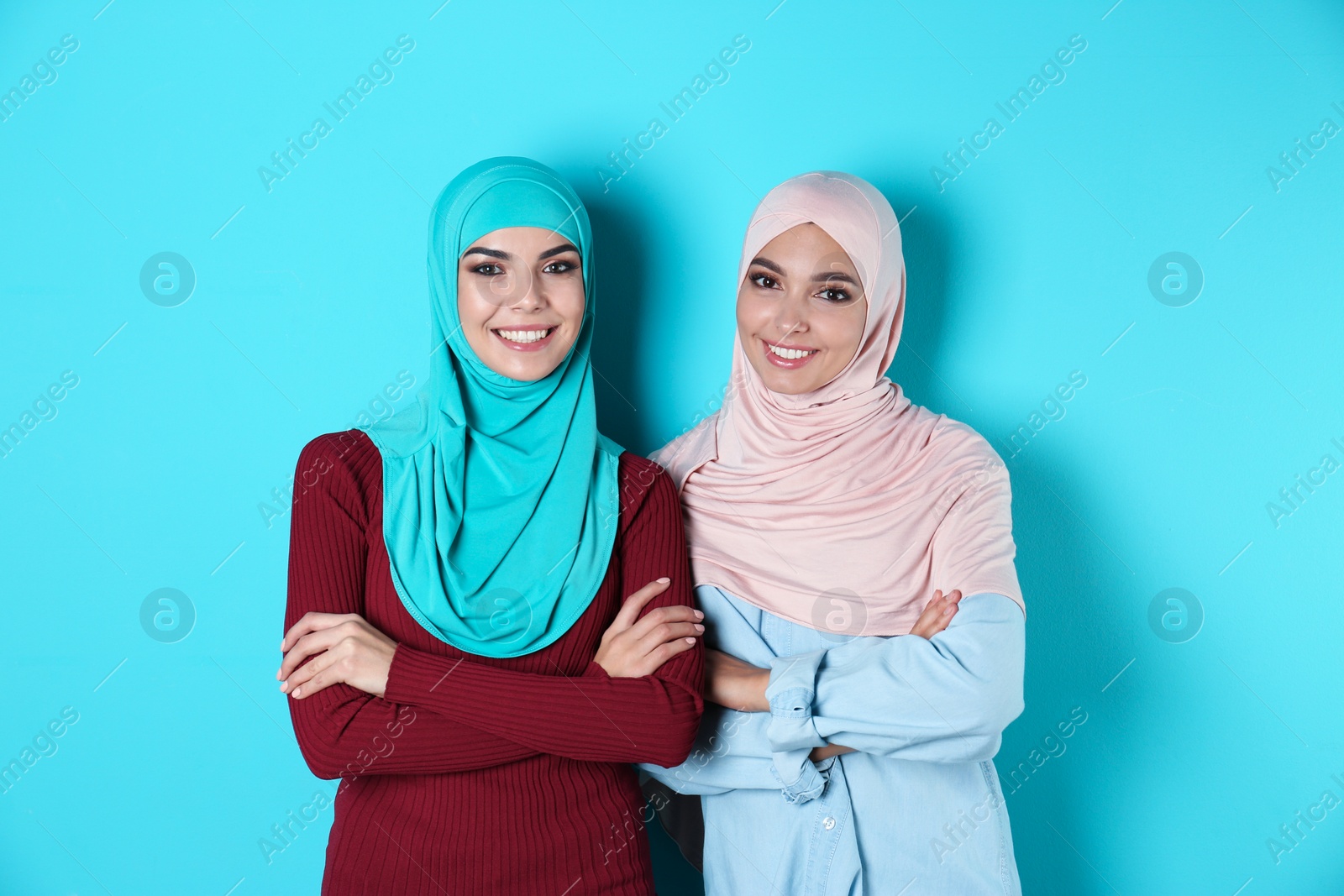 Photo of Portrait of young Muslim women in hijabs against color background