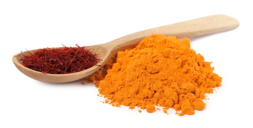 Photo of Spoon of dried flower stigmas and saffron powder on white background