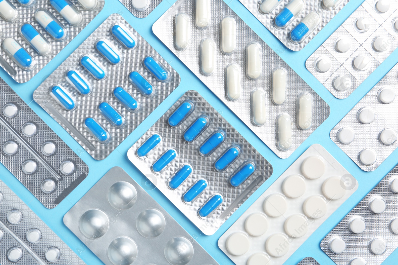 Photo of Flat lay composition with pills in blister packs on color background