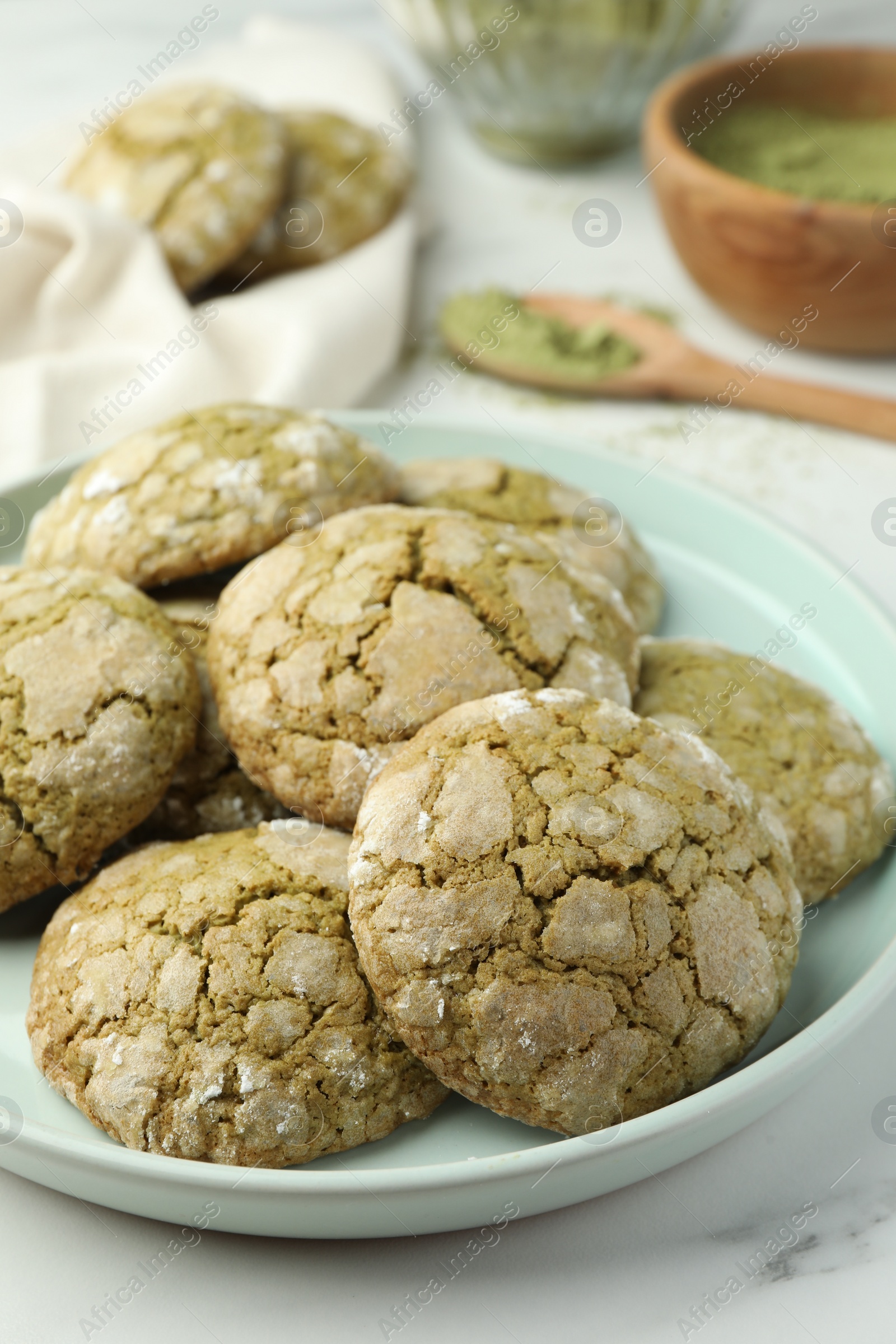 Photo of Plate with tasty matcha cookies on white table, closeup