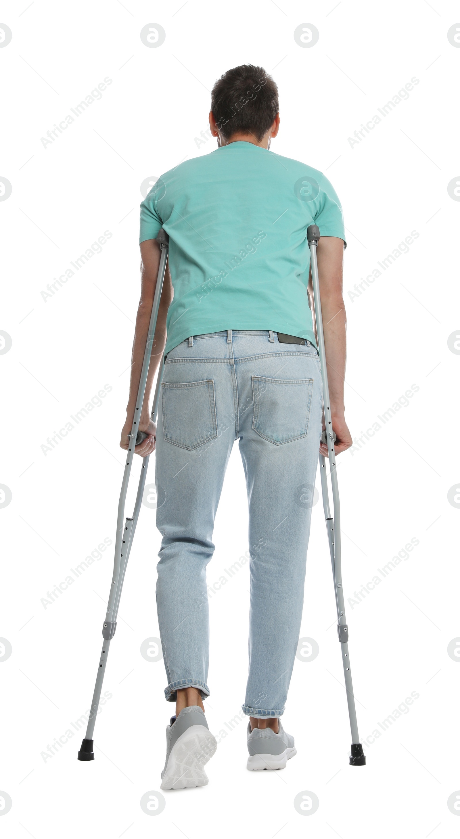 Photo of Man with crutches on white background, back view